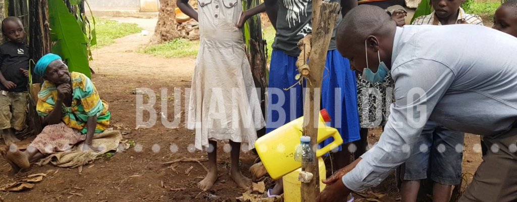 A DISTRICT HEALTH WORKER SENSITIZES LOCALS ON HOW TO UTILIZE A HOME MADE HAND WASHING FACILITY BULAMBULI DISTRICT RECEIVES NEW AMBULANCE FROM HON. SARAH WEKOMBA